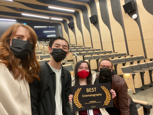 Team photo taken with the award after film screening.